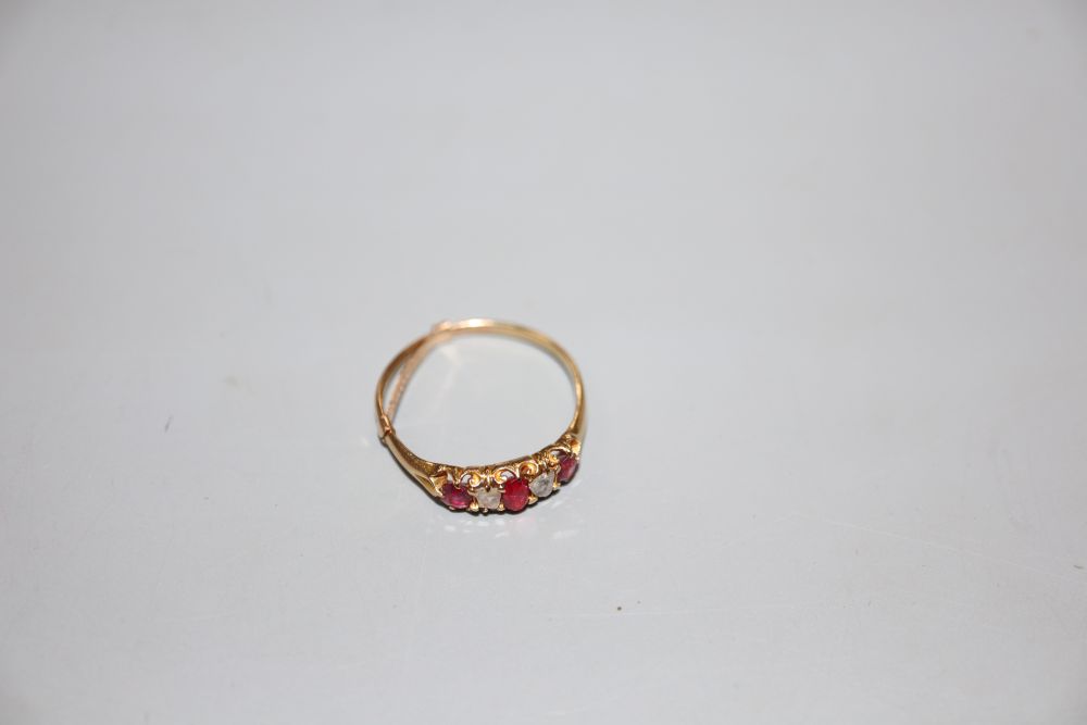 A yellow metal, ruby and diamond set five stone half hoop ring, size P, gross weight 2.2 grams.